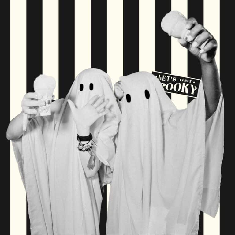 Two people dressed up like ghosts for Halloween.