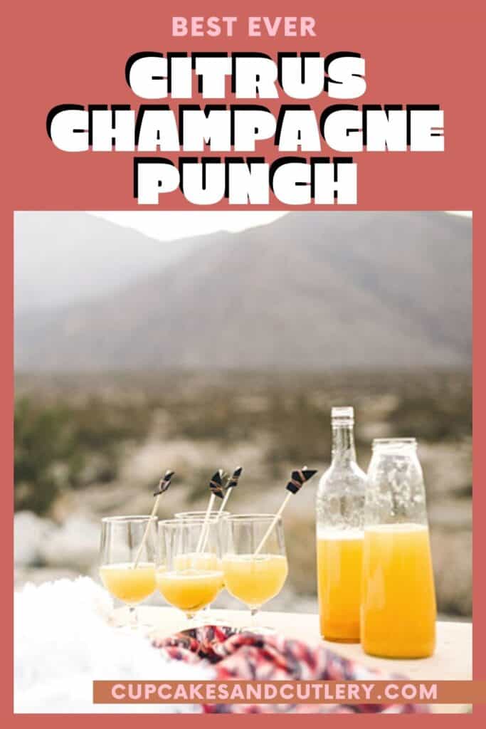 An outdoor table with glasses and bottles of a champagne punch recipe.