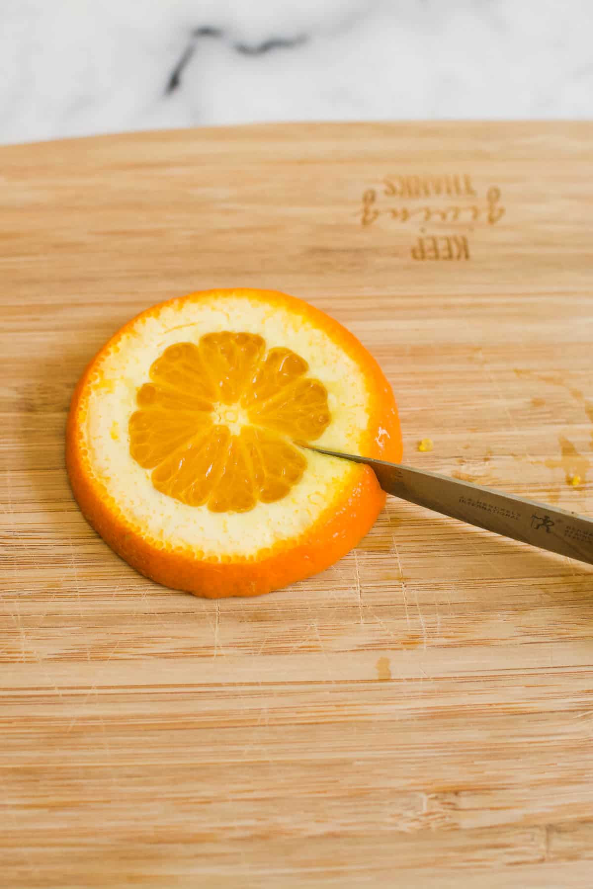 https://www.cupcakesandcutlery.com/wp-content/uploads/2022/09/how-to-make-an-orange-spiral-garnish.jpg