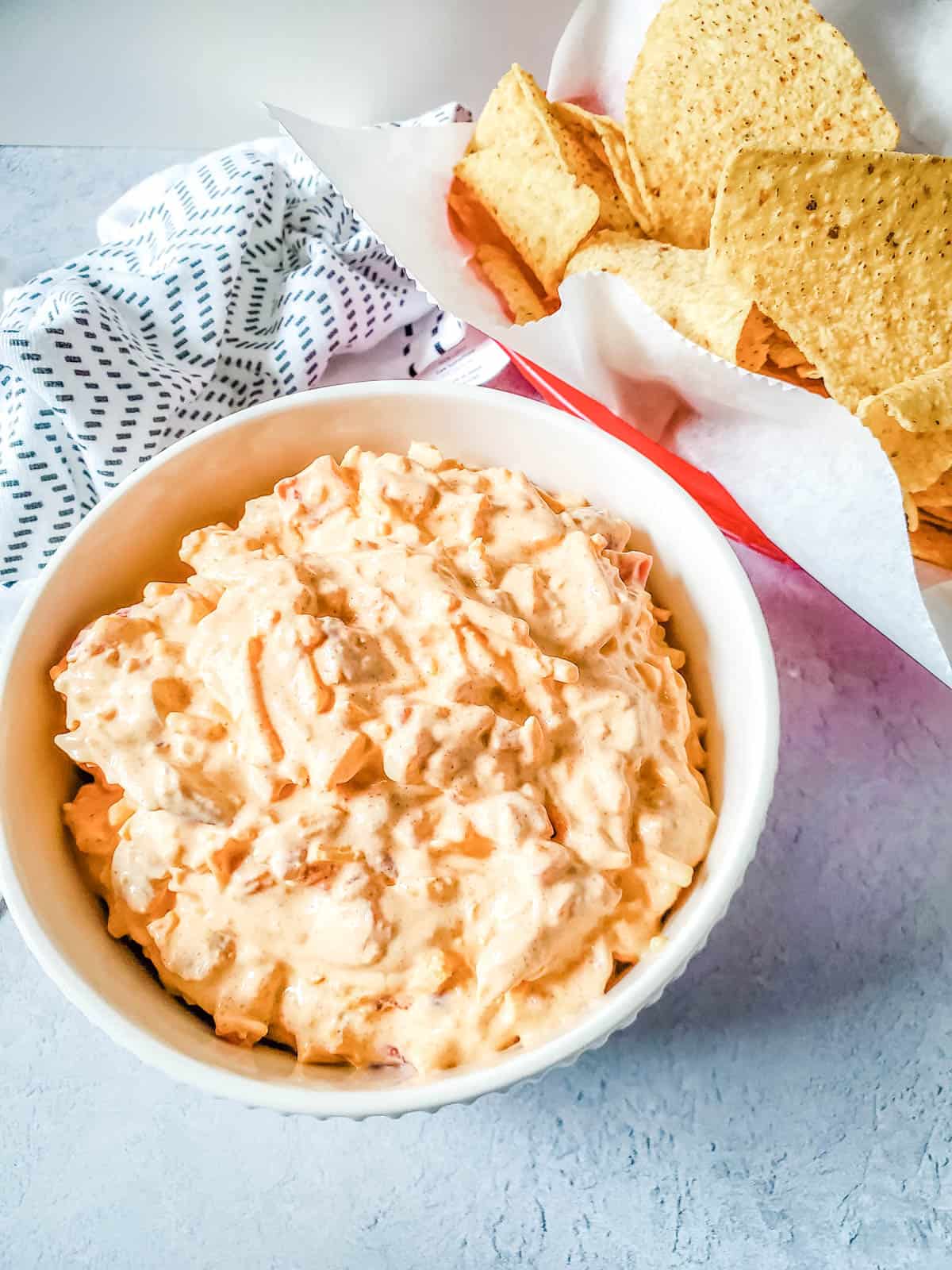 Delicious rotel boat dip with corn chips on the side.